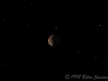 Callisto's tiny crescent above Ganymede